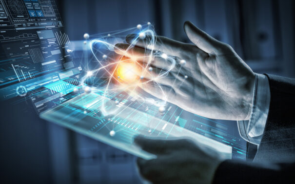 Businessman's hand interacting with a futuristic tablet interface displaying data analytics, integrated AI systems, and digital control panels in industrial applications