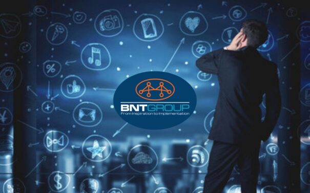 Businessman exploring digital interface with BNT GROUP logo and technology icons in a futuristic workspace