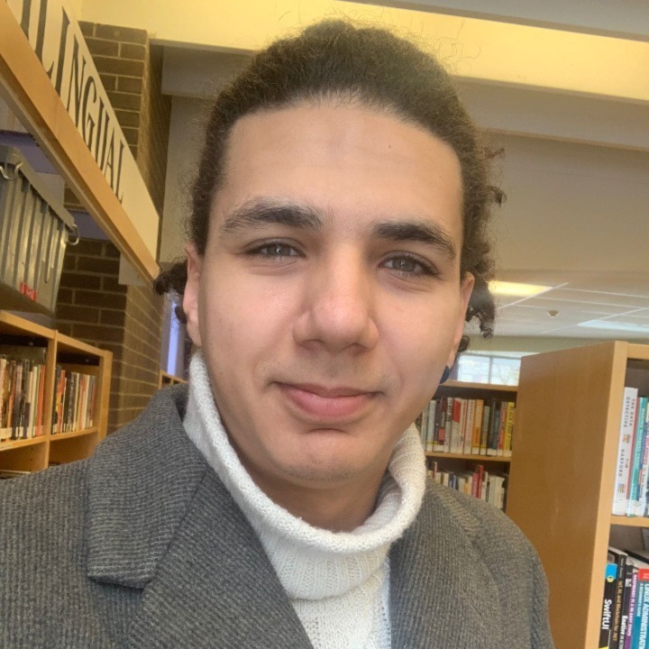 Raif Yılmaz, blog writer and technology consultant at Bridge North Inc., portrait taken in a library